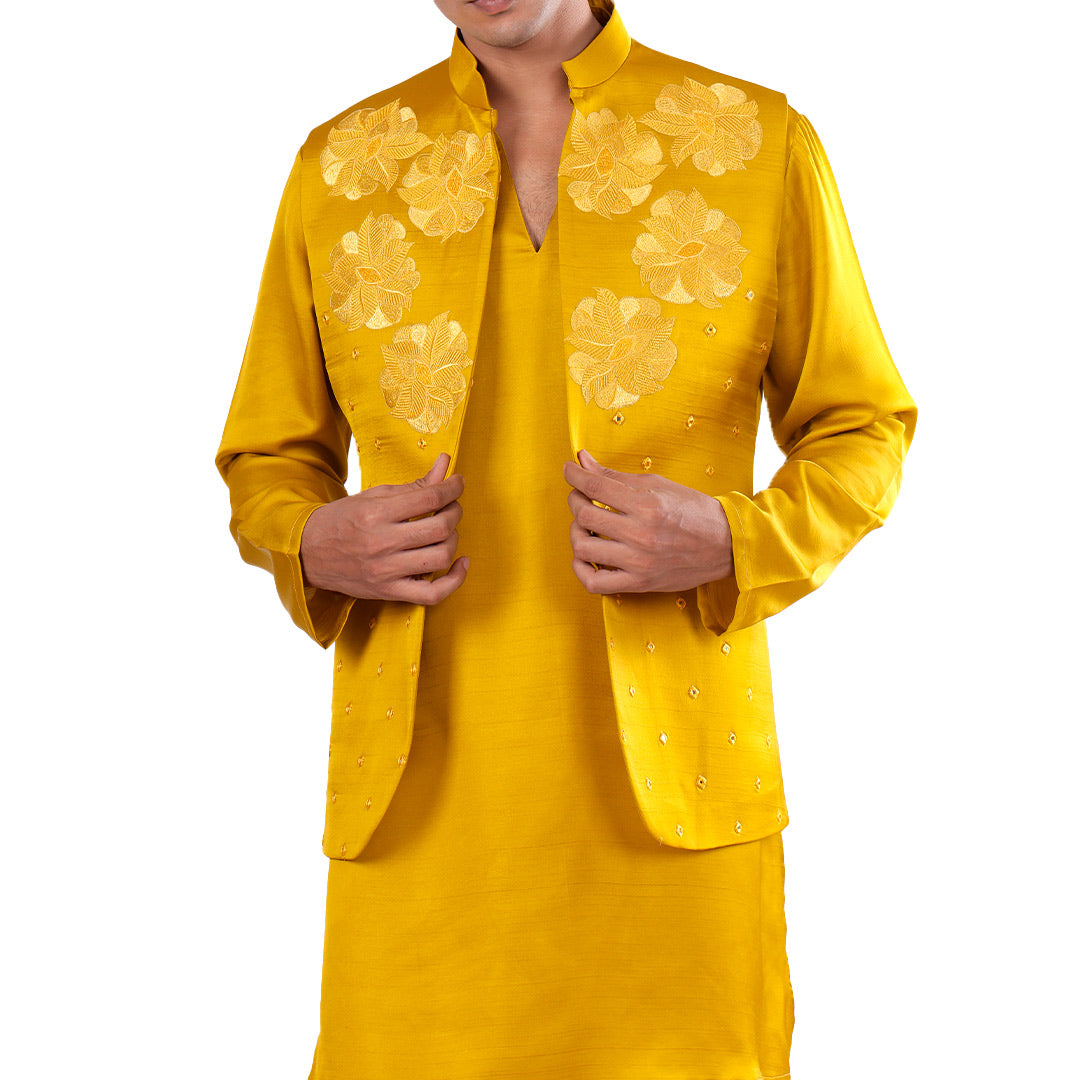 Close view of the marigold Nehru jacket front: tonal floral embroidery with mirror-work accents over the kurta