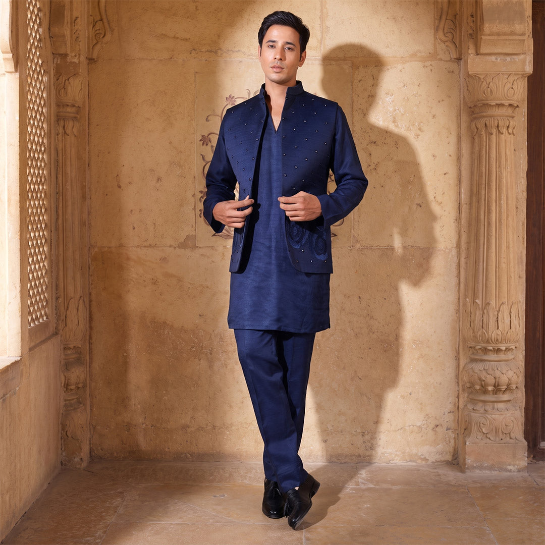 Deep Midnight navy mirror-work Nehru jacket set, model standing in a stone corridor