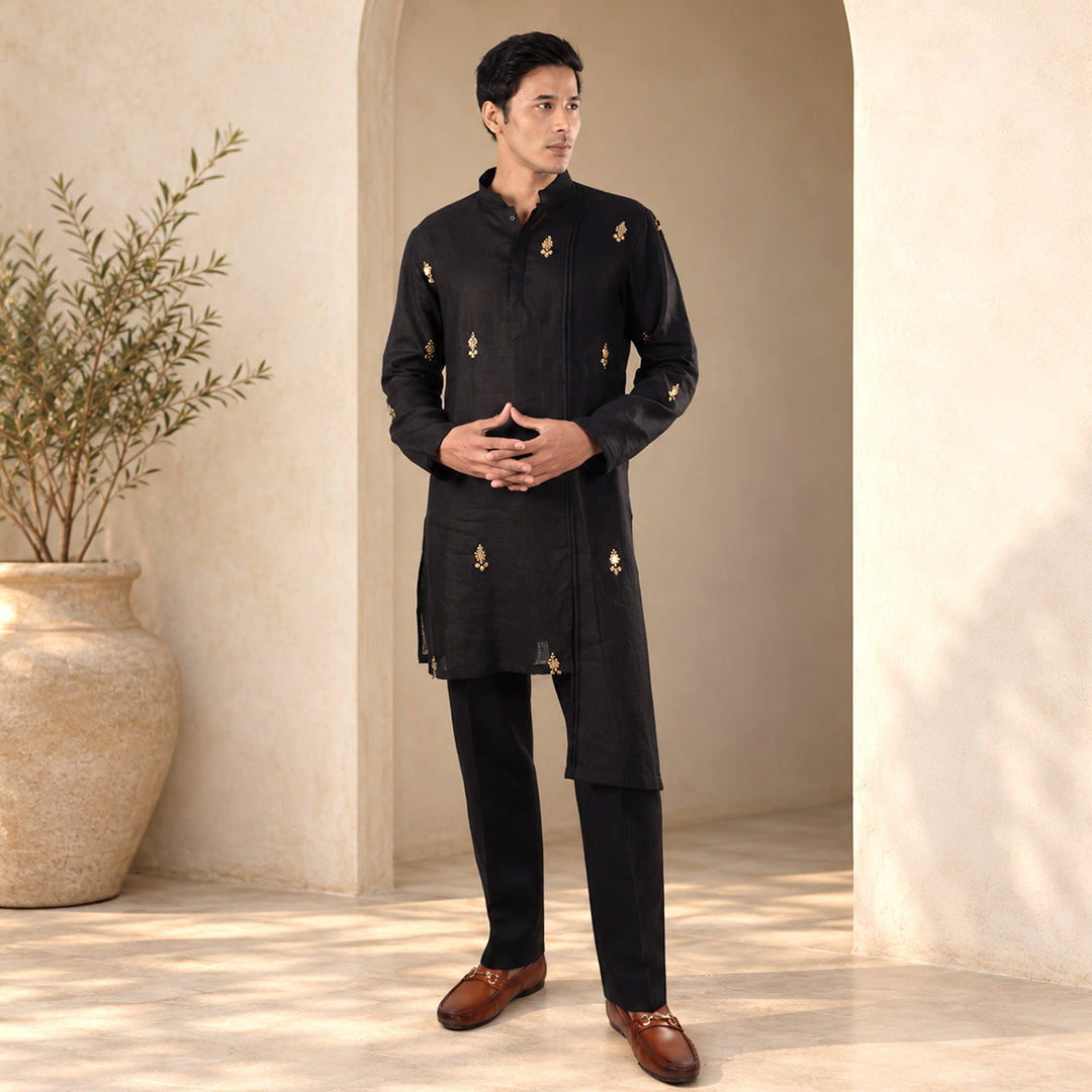 Midnight Black Monochrome Hemp Kurta Set, all black, model in an ivory arched set with an olive tree