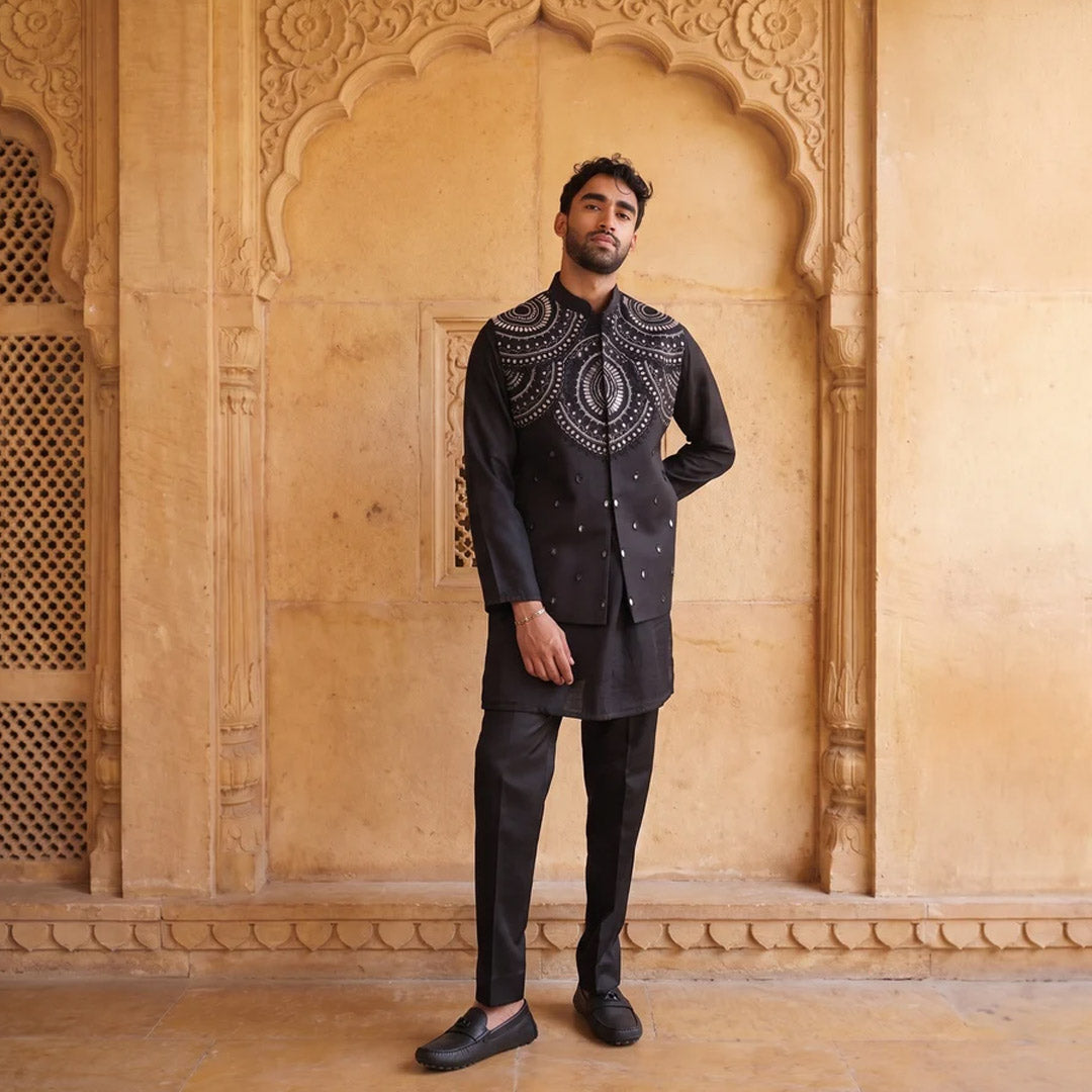 Midnight Black Mirror-Work Nehru Jacket Set, all black, model standing in a sandstone arch