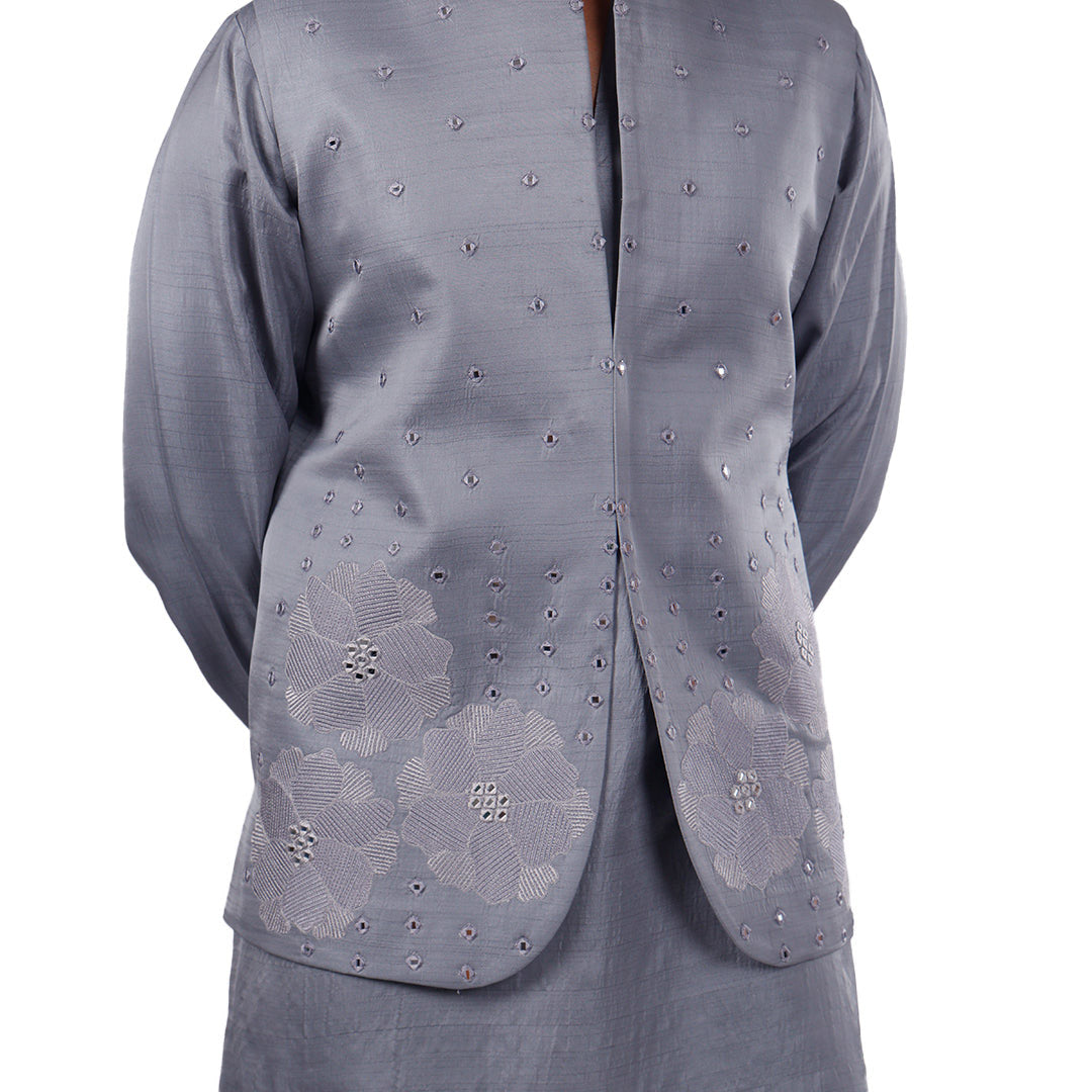 Close view of the grey Nehru jacket hem: tonal floral embroidery with mirror-work details