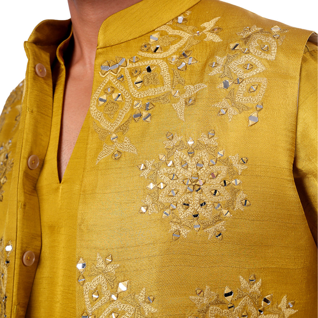 Macro detail of the citrus green Nehru jacket: symmetrical mirror-work motifs and tonal embroidery at the chest