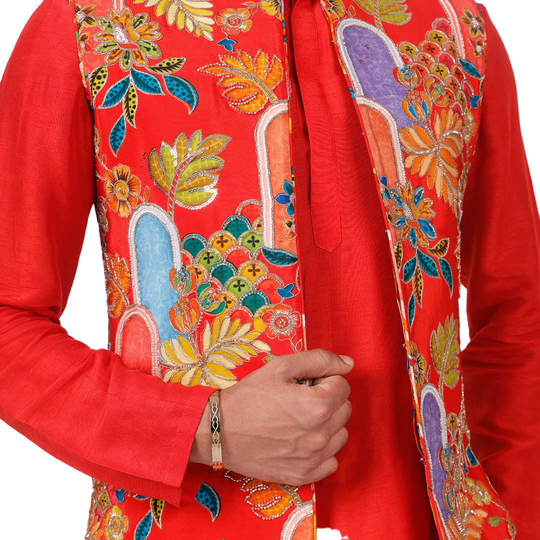 Close view of the scarlet printed Nehru jacket showing hand-embellished florals against the red kurta sleeve
