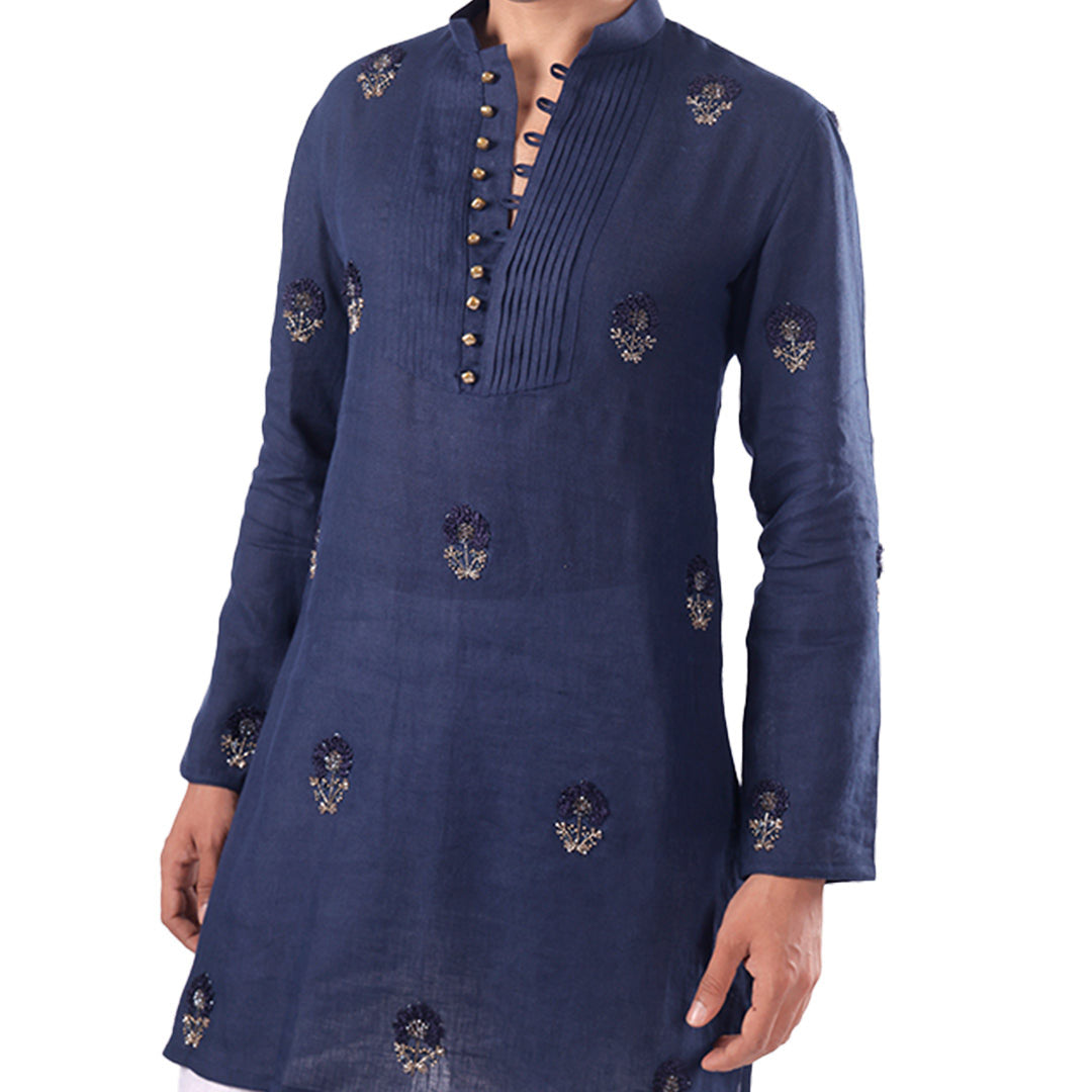 Close view of the indigo kurta front showing the buttoned bib and scattered motifs
