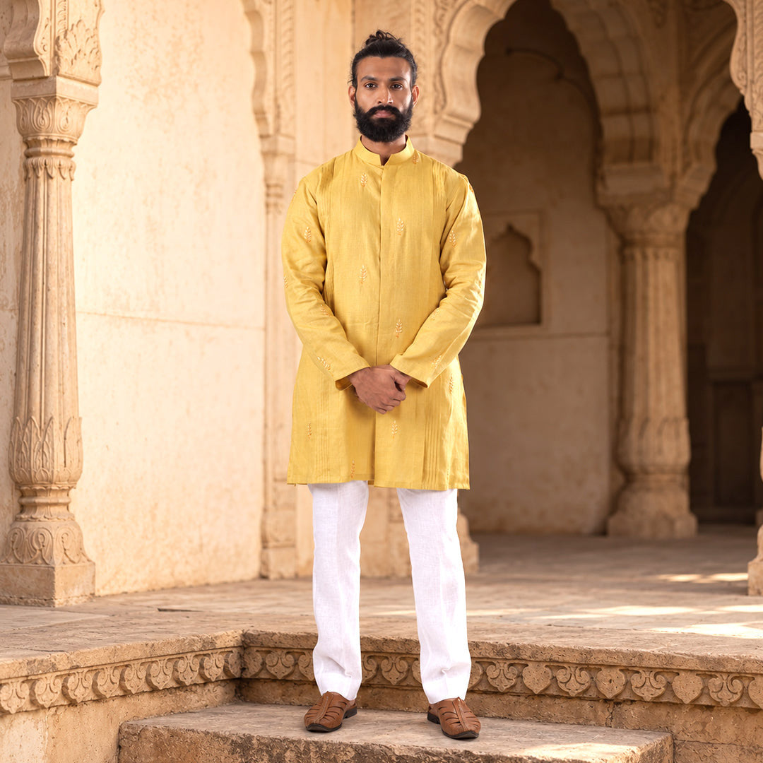 Marigold Pintuck-Columns Hemp Kurta Set with white trousers, model on the steps of a sandstone heritage arcade