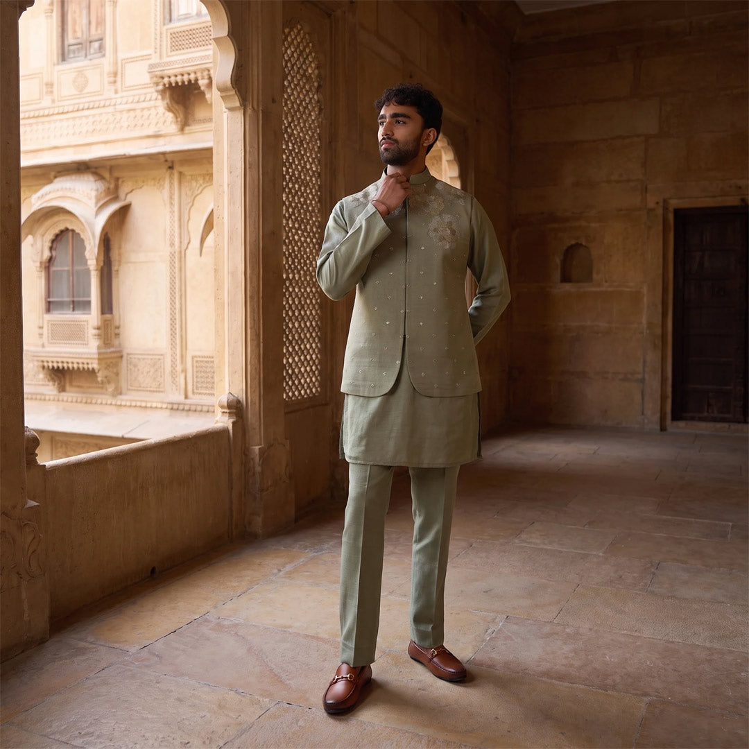 Sage Bloom Mirror-Work Nehru Jacket Set in tonal sage, model in a sandstone heritage corridor