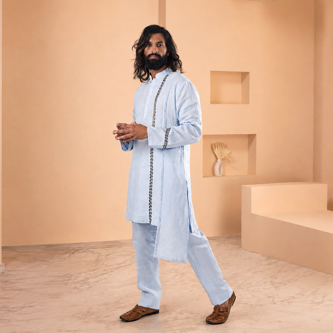 Sky Blue Asymmetric-Trim Linen Kurta Set in tonal light blue, model walking in a peach-toned set